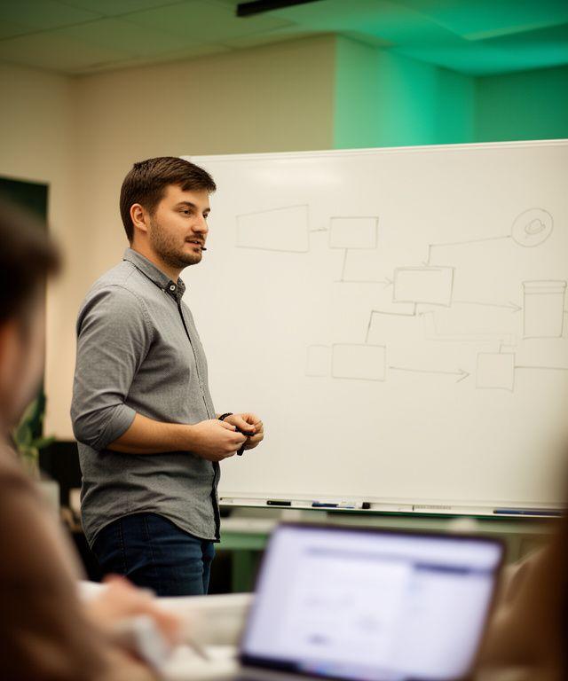 Head of product presenting a secure messenger roadmap beside a whiteboard in Kyiv
